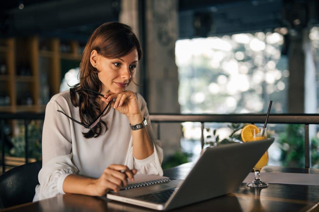 Serious woman looking and searching something online.